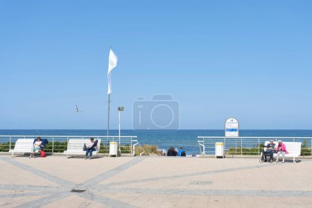 Photo for Kuehlungsborn, Germany  May 27, 2023: popular beach promenade with benches and vacationers in baltic resort Kuehlungsborn in summer in Germany - Royalty Free Image