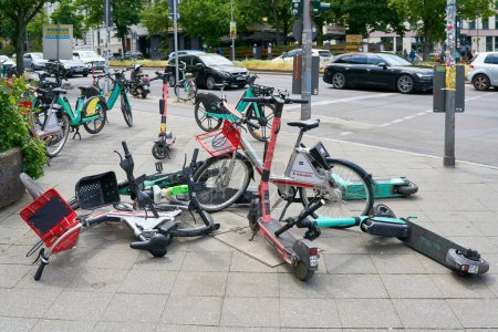 Photo for Berlin, Germany  May 29, 2023: Obstacle and chaos from unused e-scooters and bicycles on a footpath in downtown Berlin - Royalty Free Image