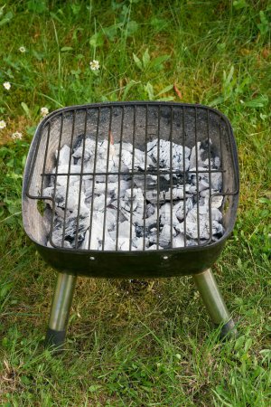 Photo for Already white charcoal glowed through in a grill for optimal grilling pleasure - Royalty Free Image