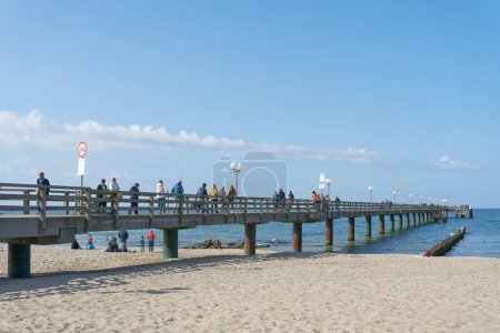 Photo for Kuehlungsborn, Germany  May 24, 2023: Holidaymakers on the popular pier of Kuehlungsborn on the German Baltic Sea coast - Royalty Free Image