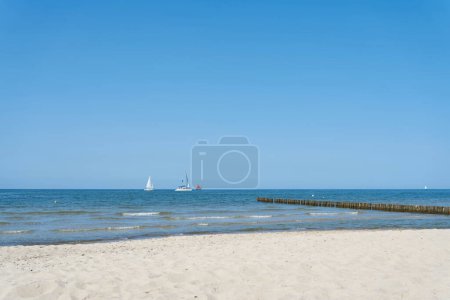 Photo for Beach near Kuehlungsborn on the German Baltic Sea with blue sky and some sailboats on the horizon - Royalty Free Image