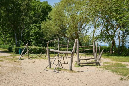 Photo for Public playground with wooden playground equipment for children near the beach in German Baltic resort Kuehlungsborn East - Royalty Free Image