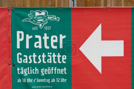 Photo for Berlin, Germany  May 30, 2023: Advertisement with directional arrow on a fence for the oldest beer garden in Berlin, the Prater in the district of Prenzlauer Berg - Royalty Free Image