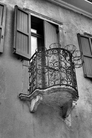 Black and white image of a historic balcony on a facade in the old town of Malcesine on Lake Garda in Italy                               