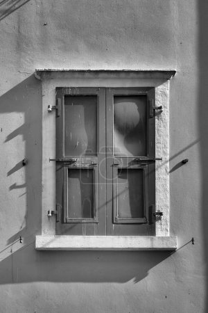  Black and white image of a window of an old house in the historic old town of Malcesine on Lake Garda in Italy                              