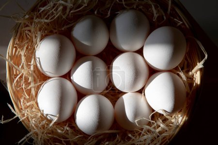 Photo for White eggs in a straw basket - Royalty Free Image