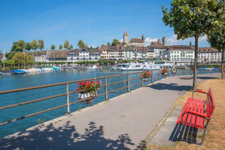Photo for Beautiful lakeside promenade with bench, tourist resort Rapperswil, view to harbor and castle. canton Sankt Gallen switzerland - Royalty Free Image