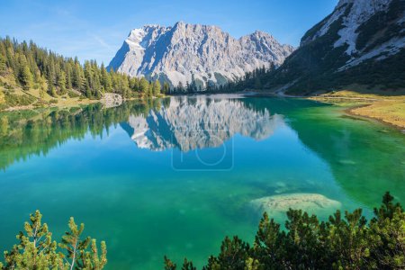 turquoise lake Seebensee and Zugspitze mountain, reflecting in the water. austrian hiking resort, landscape tirol
