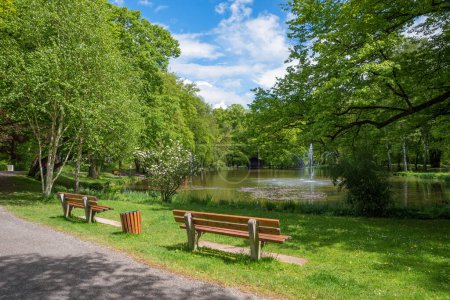 Photo for Spa garden Bad Aibling, lake Irlachsee with fountain, recreational area with benches. upper bavarian spring landscape - Royalty Free Image