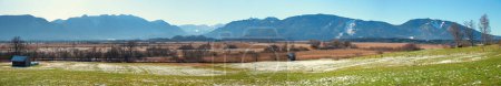 panoramic landscape Murnauer Moos, with view to bavarian alps over moorland, upper bavaria at the end of winter season