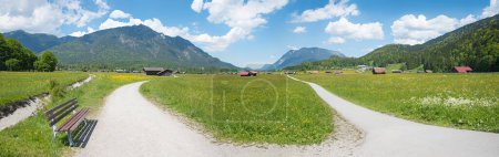 bike and hike route through rural landscape with huts and buttercup meadows, upper bavaria in spring. 