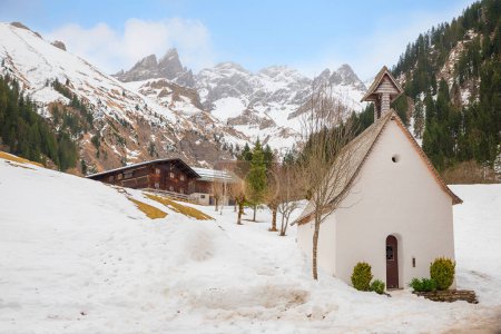 hiking destination Einodsbach, chapel and farmstead, allgau alps in winter season. landscape near Oberstdorf