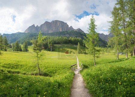 walkway around Colfosco tourist resort, Dolomite Alps, near Grodner Joch. idyllic spring landscape south tyrol
