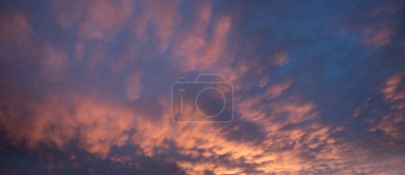 colorful sunset sky background with mammatus clouds, orange and purple colored