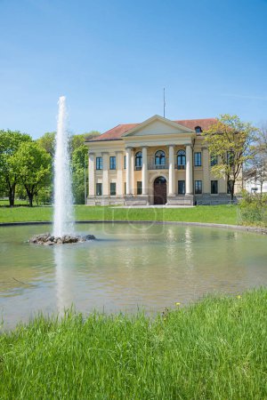 Munich mansion Prinz-Carl-Palais, with pond and fountain. Former official residence of the Bavarian Prime Minister. Maxvorstadt district. springlike park