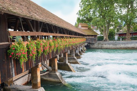 wooden weir with decorative flowers, Aare river Thun, switzerland Bernese Oberland