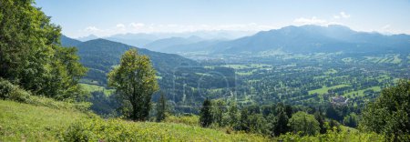 Cultural landscape near Lenggries with parallel tree hedges. View from Sunntraten mountain. upper bavaria in summer. brauneck mountain.