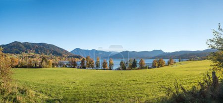autumnal landscape bavaria, view to lake Tegernsee, Gmund lakeside, in october. blue sky with copy space