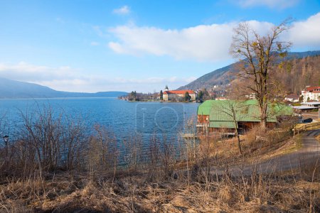 view to lake Tegernsee, boathouses and castle. tourist resort upper bavaria in march