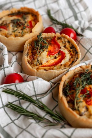 A delectable tomato and herb tart showcasing fresh cherry tomatoes, baked perfectly on a rustic wooden board