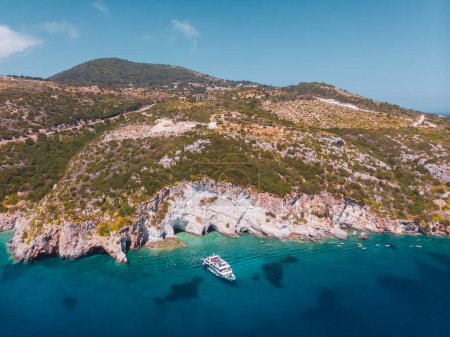 Foto de Drone shot of Zakynthos island with beautiful turquoise Ionian sea and limestone cliffs and cave near famous Navagio beach during daytime in Greece - Imagen libre de derechos