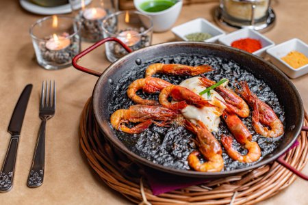 Photo for Paella with prawns and black rice - Royalty Free Image