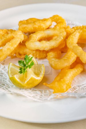 Photo for Freshly made Roman calamars with lemon wedge - Royalty Free Image