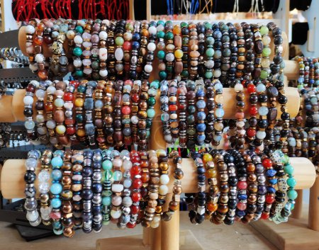 Traditional oriental multicolored bracelets made of round natural stones on the shop window