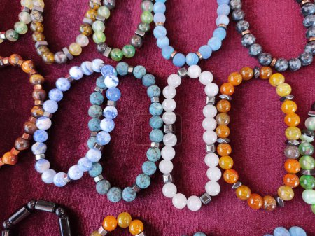  Beautiful wrist bracelets made of multicolored round stone beads on the shop window
