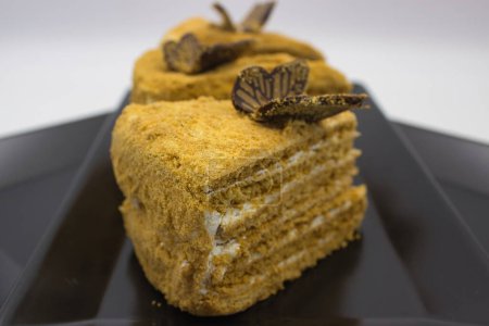 Multi-layered honey cake garnished with a chocolate butterfly