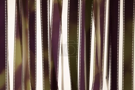Photo for Veiled fragments of 35 mm film on white surface. Cinematography concept. - Royalty Free Image