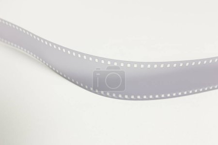 Photo for Translucent fragment of 35 mm movie on white surface. - Royalty Free Image
