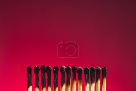 Photo for Set of burnt matches on red gradient background. Team burnout concept. - Royalty Free Image