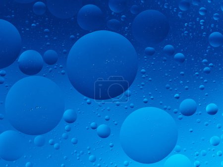Photo for Macro shot of blue oil bubbles of different sizes in water, creating a serene abstract image. - Royalty Free Image