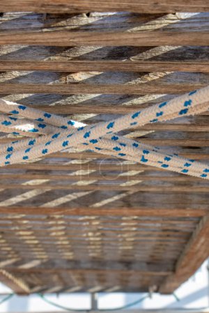 Photo for Wooden boat gangway seen from below with holding rope - Royalty Free Image