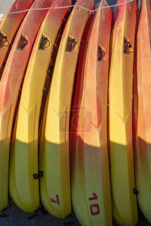 Photo for Kayaks stowed like sardines on the edge - Royalty Free Image
