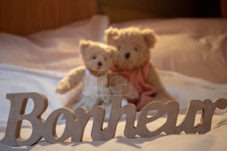 Photo for Concept joy and happiness - sweetness of life of childhood, 2 teddy bears and the word happiness (bonheur is happiness in French) - Royalty Free Image