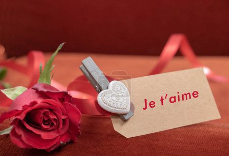 Téléchargez les photos : "Déclaration d'amour Je t'aime écrite en français sur une carte avec une rose rouge - en image libre de droit