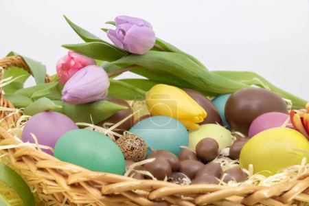 Easter with soft colors and pastel with chocolate eggs and tulips
