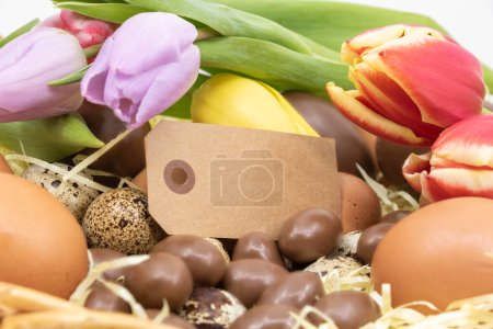  Etikett, Schokoeier, Wachteleier sowie Hühnereier und Tulpen zu Ostern