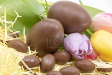 Easter with soft colors and pastel with chocolate eggs and tulips