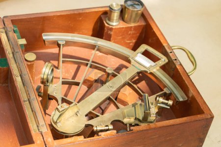 Old sextant and traditional navy for boat captain to make his course and find his way