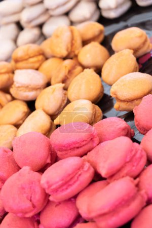 Bunch of macaroons with caramel, raspberry and hazelnut delicious traditional cakes Production and tradition of Provence, south of France, Cte d'Azur