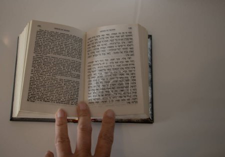 Foto de El libro sagrado el Corán y la mano sobre fondo blanco - Imagen libre de derechos