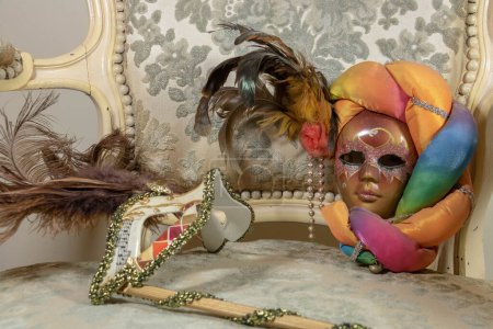 Photo for Different styles of carnival masks on rococo wing chair - Royalty Free Image