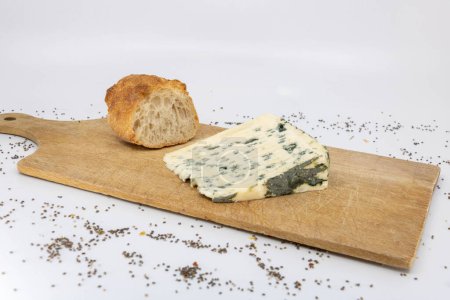 Roquefort and baguette on a wooden cutting board