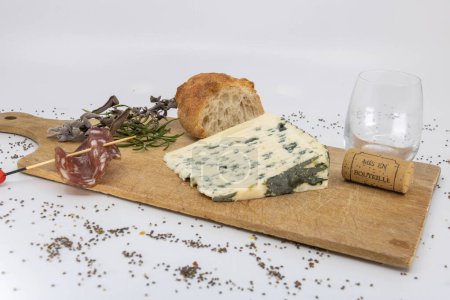 Roquefort and baguette on a wooden cutting board