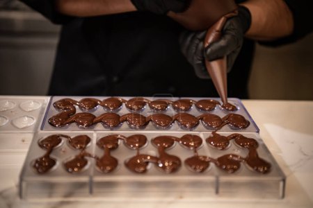 Chocolatier is preparing chocolate pralines