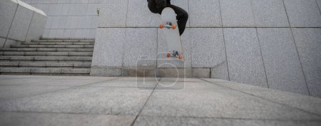 Photo for Skateboarder skateboarding in modern city - Royalty Free Image