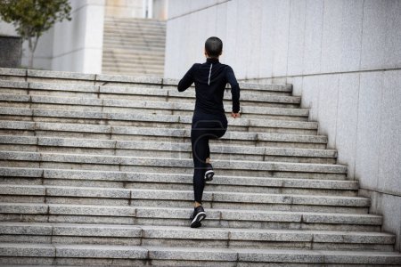 Photo for Fitness woman running up stairs in city - Royalty Free Image
